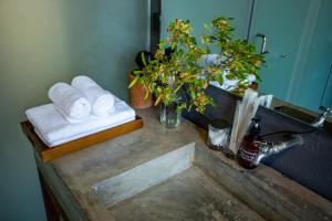 a bathroom counter with towels and a sink at Rock Bay by Chành Rành in Vĩnh Hy +103 photos