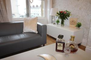 a living room with a couch and a table at Cornerhouse Apartments 3 Sleeps 7 in Llandudno