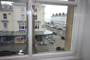 a window with a view of a city street at Cornerhouse Apartments 3 Sleeps 7 in Llandudno