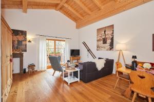 a living room with a couch and a table at Ferienwohnung Dosbach in Reit im Winkl