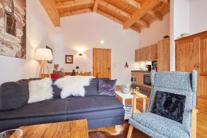 a living room with a couch and a chair at Ferienwohnung Dosbach in Reit im Winkl