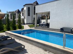 a swimming pool in the backyard of a house at Fabulous Villa In Yerevan. in Yerevan