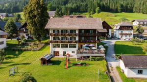 an aerial view of a large house with a playground at Hotel Lipeter & Bergheimat in Weissensee