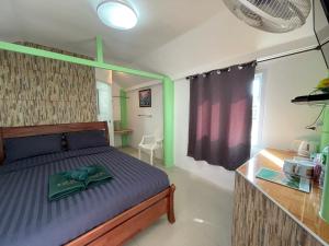 a bedroom with a bed and a table and a window at TopCats Fishing Resort in Taling Ngam Beach +21 photos