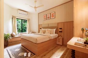 a bedroom with a large bed and a window at Olive Resort - Sillari Pench in Silāri +35 photos