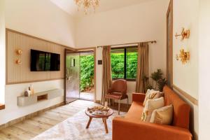 a living room with a couch and a table at Olive Resort - Sillari Pench in Silāri
