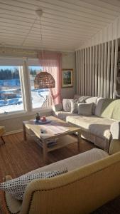 a living room with two couches and a table at Säbytorp in Kil