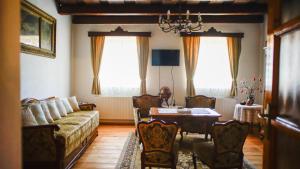 a living room with a couch and a table at Antik Porta-Hangulatos parasztház kerttel,borospincével és infraszaunával in Szakony
