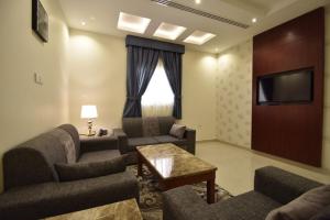 ein Wohnzimmer mit Sofas und einem Flachbildfernseher in der Unterkunft ابات للشقق المخدومة ABAT Serviced Apartment in Riad