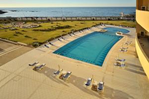 an overhead view of a swimming pool and the ocean at Corinthia Tripoli in Tripoli