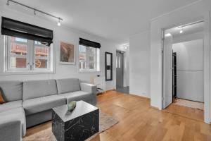 a living room with a couch and a table at Northstay - Skansegata Apartments, Apartment B l One-Bedroom in Tromsø