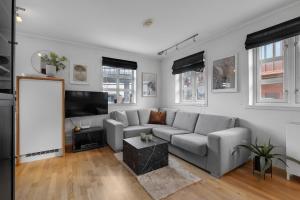 a living room with a couch and a flat screen tv at Northstay - Skansegata Apartments, Apartment B l One-Bedroom in Tromsø