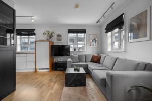 a living room with a couch and a table at Northstay - Skansegata Apartments, Apartment B l One-Bedroom in Tromsø