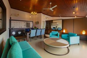 a living room with a couch and a table and chairs at The Pinnacle Ella Boutique Hotel and Spa in Ella