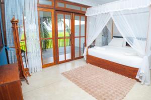 a bedroom with a bed with a canopy at Heaven Upon Rice Fields in Anuradhapura