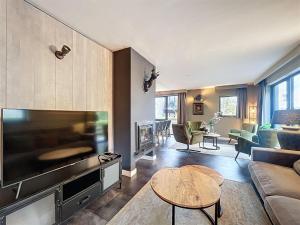 a living room with a large flat screen tv at DURBUY au "trois marcassins" in Durbuy