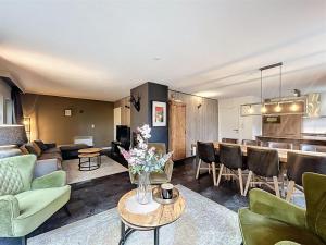a living room with a couch and a table at DURBUY au "trois marcassins" in Durbuy