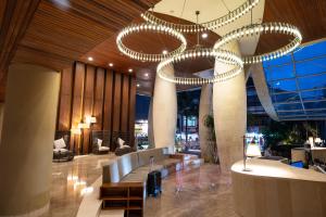 a lobby with a large chandelier in a building at Bedrock Hotel Kuta in Kuta