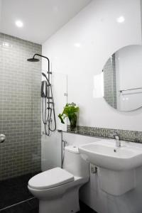 a bathroom with a toilet and a sink and a mirror at Tanner House Krabi in Ban Klang +70 photos