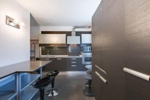 a kitchen with a table and some chairs in it at CasalFattoria in Rome