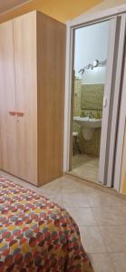 a bedroom with a door to a bathroom with a tub at B&B Casa Mia in Alghero +92 photos