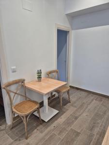 a table and two chairs in a room at Pinedo Playa Holiday 2 in Valencia +6 photos