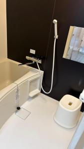 a bathroom with a white toilet and a sink at 楽校うらしり in Uwajima