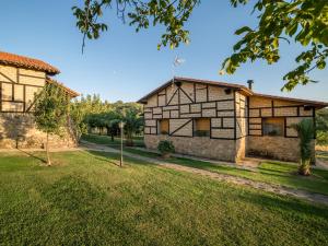 an exterior view of a house with a yard at Las Cabañas de La Vera in Aldeanueva de la Vera