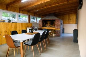 a dining room with a table and a brick oven at Kuća za odmor Aria in Krapina