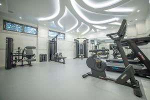 a gym with treadmills and machines in a room at Rhodos Horizon Marina - Adults Only in Rhodes Town