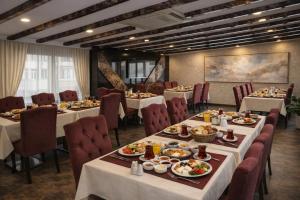 a dining room with tables and chairs with food at Rain Golden Hotel in Istanbul