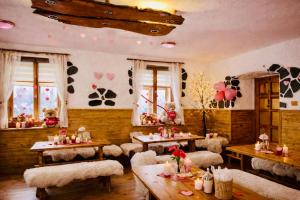 a dining room with tables and chairs and windows at pension U Jiřího in Ludvíkov