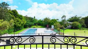 a view of a swimming pool from a balcony at The Ancestry Suites in Wasig