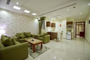 sala de estar con sofá y mesa en Abat Suites, en Riad