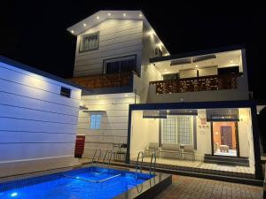 a house with a swimming pool in front of a house at Yelagiri castle in Yelagiri