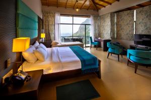 a hotel room with a bed and a desk and a room at The Pinnacle Ella Boutique Hotel and Spa in Ella +21 photos