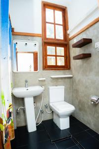 a bathroom with a toilet and a sink at Heaven Upon Rice Fields in Anuradhapura +41 photos