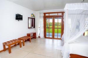 a bedroom with a bed and a sliding glass door at Heaven Upon Rice Fields in Anuradhapura