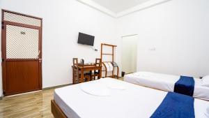 a room with two beds and a television in it at OKI Nature Resort in Dambulla +53 photos