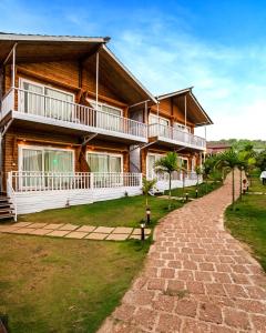 a house with a walkway in front of it at Dallas Beach Resorts Ashvem Beach in Mandrem