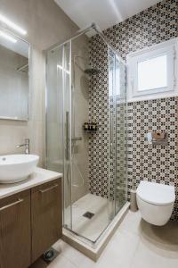 a bathroom with a shower and a toilet and a sink at Zoe's Luxury Living in Volos