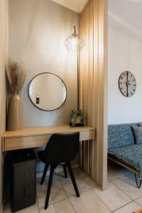 a desk with a mirror and a chair in a room at Zoe's Luxury Living in Volos