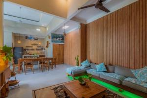 a living room with a couch and a table at Gemello Bali Villa in Keramas