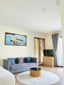 a living room with a couch and a table at Bin Bin Coastar Villa Hồ Tràm in Ho Tram