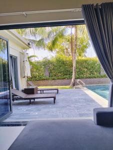 a living room with a pool and a patio at Bin Bin Coastar Villa Hồ Tràm in Ho Tram