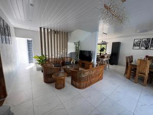 a living room with wicker chairs and a table at Authentica Private Villa by Oceanaxe Holidays in Calodyne