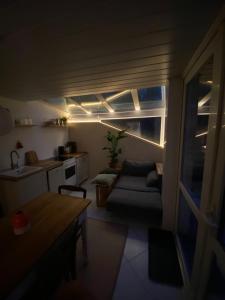 a small living room with a couch and a table at Souterrainwohnung mit Badesteg an der Paar in Friedberg