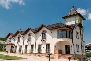 a large white building with a turret at Hotel Kazak Club in Chişinău