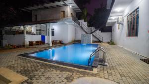 a swimming pool in the middle of a house at OKI Nature Resort in Dambulla