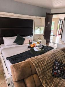 a large bed with a tray of food on it at Ui Views in Margate